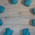 Blue wool yarn on a wooden background