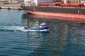 Blue Work Boat Past Tanker