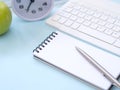 Blue workplace desk table with a notebook and pen. Royalty Free Stock Photo