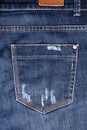 Blue worn jeans pocket close up, ripped jeans pocket background, dark blue damaged denim backdrop, torn jeans pocket pattern Royalty Free Stock Photo