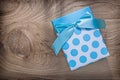 Blue wrapped present box on wooden board celebrations concept