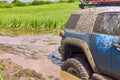 Blue 4x4 off-road car got stuck in a swamp during extreme competitions. Royalty Free Stock Photo