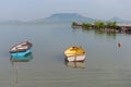Blue and yellow boats on lake Balaton with the Badacsony mountain in the background