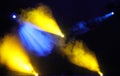 Blue and yellow colored light show over concert stage