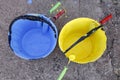 Blue and yellow colored paints in bucket