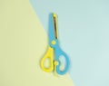 Blue and yellow colourful scissors on on blue and green background. beautiful colourful picture concept The same as the difference Royalty Free Stock Photo