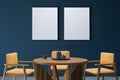 Blue and yellow dining room with two empty canvases Royalty Free Stock Photo