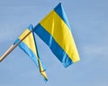 Blue and yellow flags against sky Royalty Free Stock Photo