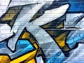 Blue and yellow graffiti detail on a brick wall Royalty Free Stock Photo