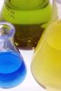 Blue, yellow and green chemicals in flasks