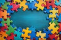 Blue, yellow, green, red pieces of puzzle frame on wooden background with copy space for text. World autism awareness Royalty Free Stock Photo