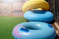 Blue and yellow inflatable wheels against background of wooden fence and nature Royalty Free Stock Photo