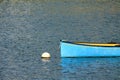 Blue yellow kayak canoe floating in harbor isolated Royalty Free Stock Photo