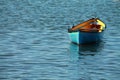 Blue yellow kayak canoe floating in harbor isolated Royalty Free Stock Photo
