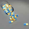 Blue and yellow pills and bottle Royalty Free Stock Photo