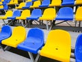 Blue and yellow plastic chairs on the street or at the stadium Royalty Free Stock Photo