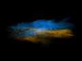 Blue and yellow powder explosion isolated on black Royalty Free Stock Photo