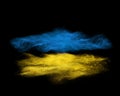 Blue and yellow powder explosion isolated on black