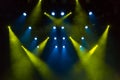 Blue and yellow rays of light through the smoke on stage. lighting equipment. Spotlight Royalty Free Stock Photo