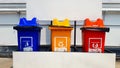 Blue, yellow and red bins for separate trash for reuse and disposal at park. Colorful trashcan for dumping used stuff or material