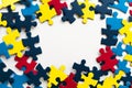 Blue, yellow, red pieces of puzzle frame on white background. World autism awareness day concept. Top view, copy space Royalty Free Stock Photo