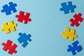 Blue, yellow, red pieces of puzzle on light blue frame background. World autism awareness day concept. Top view, copy Royalty Free Stock Photo