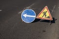 Blue and yellow-red safety signs warning about road works.The road is under construction or repair. Repair work in the Royalty Free Stock Photo