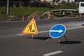 Blue and yellow-red safety signs warning about road works.The road is under construction or repair. Repair work in the Royalty Free Stock Photo