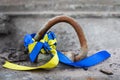 blue-yellow ribbon tied to the weapon. War with Ukraine Royalty Free Stock Photo