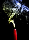 Blue and Yellow smoke from an extinguished red candle Royalty Free Stock Photo