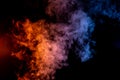 Blue and Yellow Wisps of Smoke Gather Over a Black Background Royalty Free Stock Photo