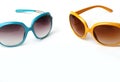 Blue and yellow sunglasses on a white background Royalty Free Stock Photo