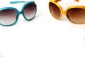 Blue and yellow sunglasses on a white background Royalty Free Stock Photo