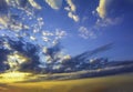 Blue yellow sunny sky and clouds background of dramatic cloudscape and skyscape with clouds in sunset Royalty Free Stock Photo