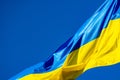 Blue and yellow Ukrainian flag waving on windy day