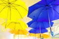 Blue and yellow umbrellas on a light background Royalty Free Stock Photo