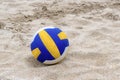 Blue and Yellow Volleyball on the beach and footprint on the sands Royalty Free Stock Photo