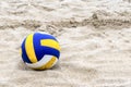 Blue and Yellow Volleyball on the beach and footprint on the sands Royalty Free Stock Photo