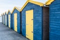 Blue and yellow wooden beach huts Royalty Free Stock Photo