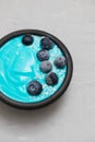 Blue yogurt with berries in the black bowl Royalty Free Stock Photo