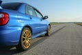 The blue youngtimer sports car on the concrete runway