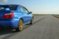 The blue youngtimer sports car on the concrete runway