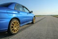 The blue youngtimer sports car on the concrete runway