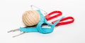 Blue zipper, red scissors and ball of beige threads with a pin Royalty Free Stock Photo