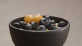 blueberries in black bowl with physalis closeup