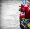 Blueberries and blueberry juice. On black wooden background. Royalty Free Stock Photo