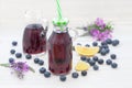 Blueberries and blueberry juice on white board Royalty Free Stock Photo