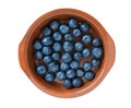 Blueberries in a clay plate isolated on a white background. Fresh bilberry. Flatlay closeup.