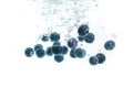Blueberries falling into water on white background Royalty Free Stock Photo