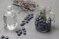 Blueberries in a glass jug with water. Water bottle. Lavender and blueberries on the table